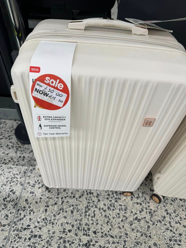 a white suitcase with a sale tag on it