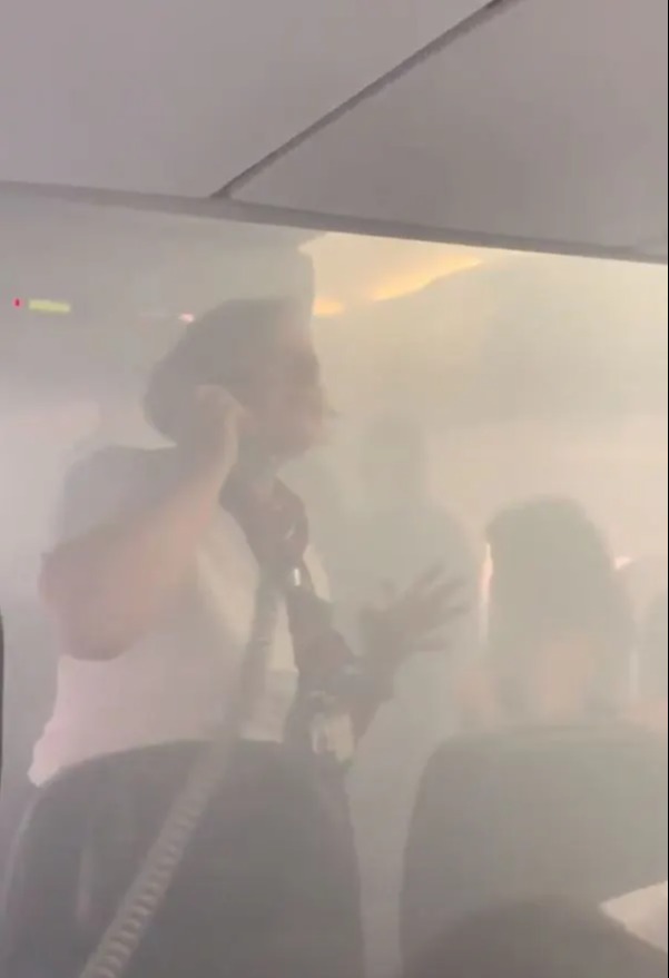 A flight attendant making a frantic call from the smoked-filled British Airways plane