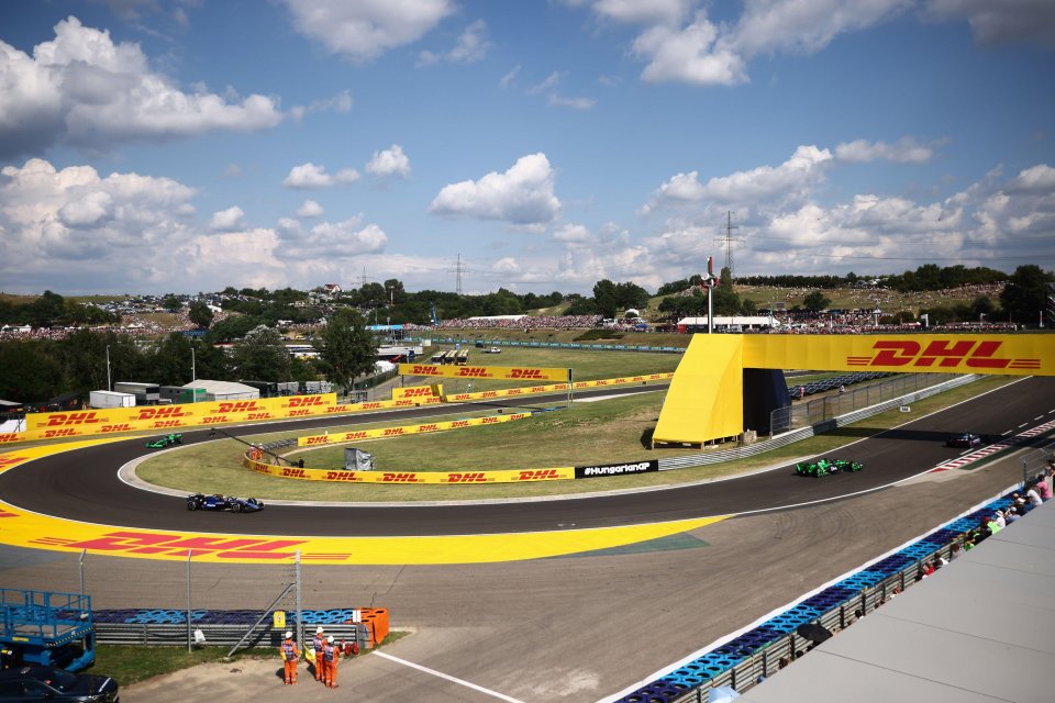 a race track with dhl banners on the side