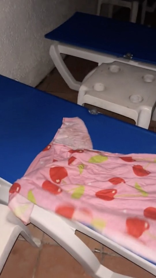 a blue chair with a pink blanket on it