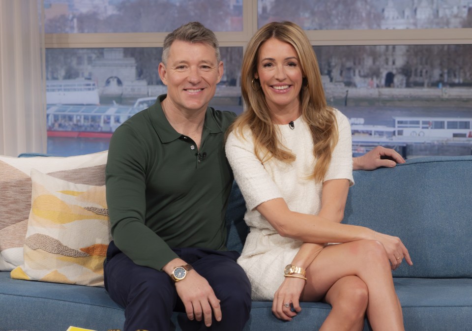 a man and a woman are sitting on a blue couch