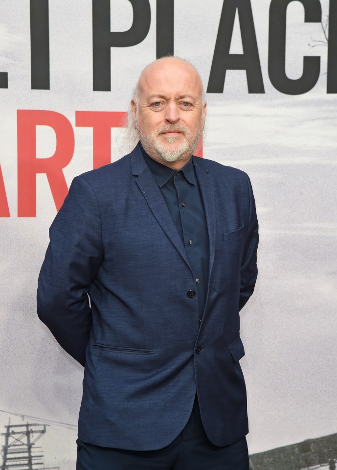 a man in a suit stands in front of a sign that says " i place "