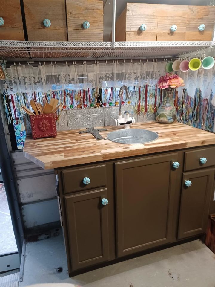 a kitchen with brown cabinets and blue knobs