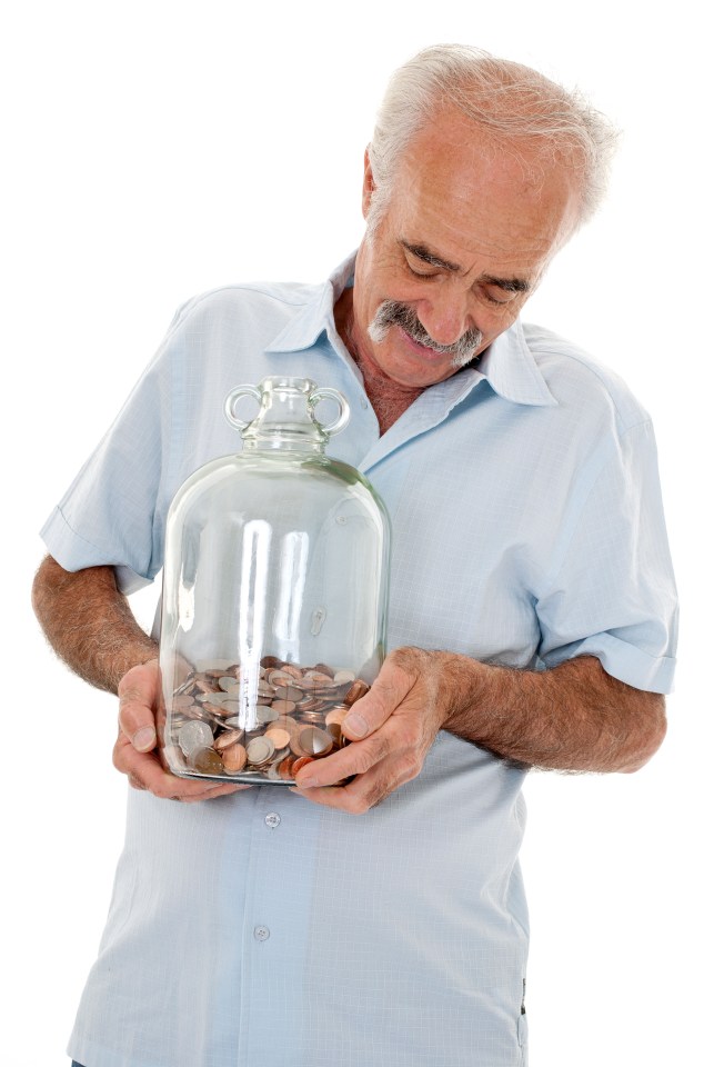 an older man is holding a jar full of coins