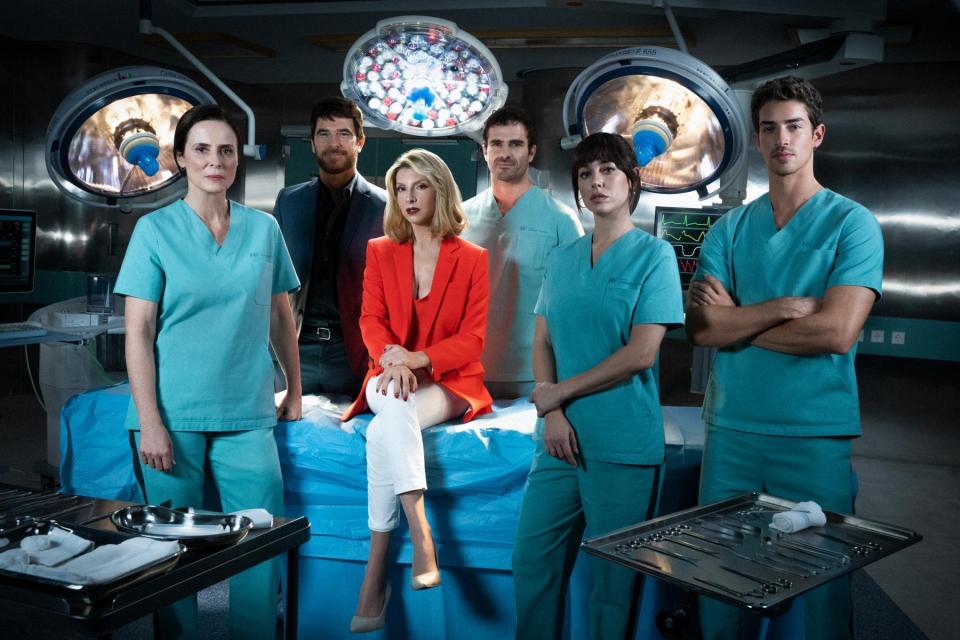 a group of doctors and nurses pose in an operating room