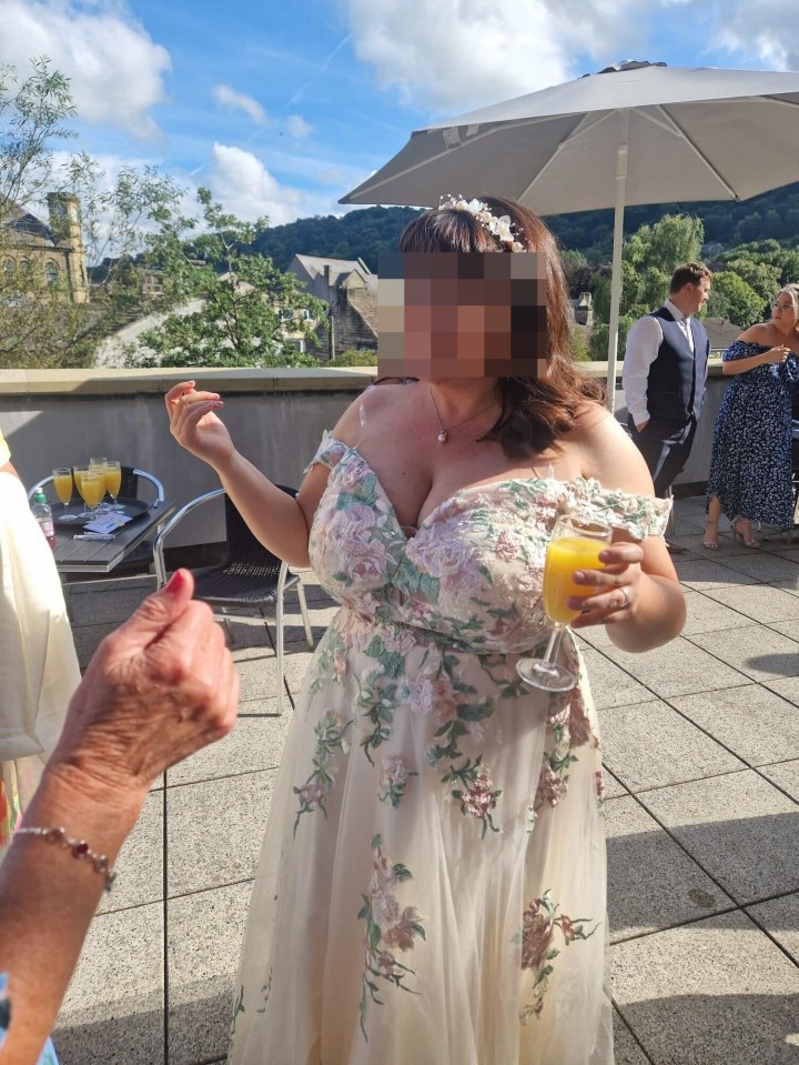 a woman in a wedding dress is holding a glass of orange juice