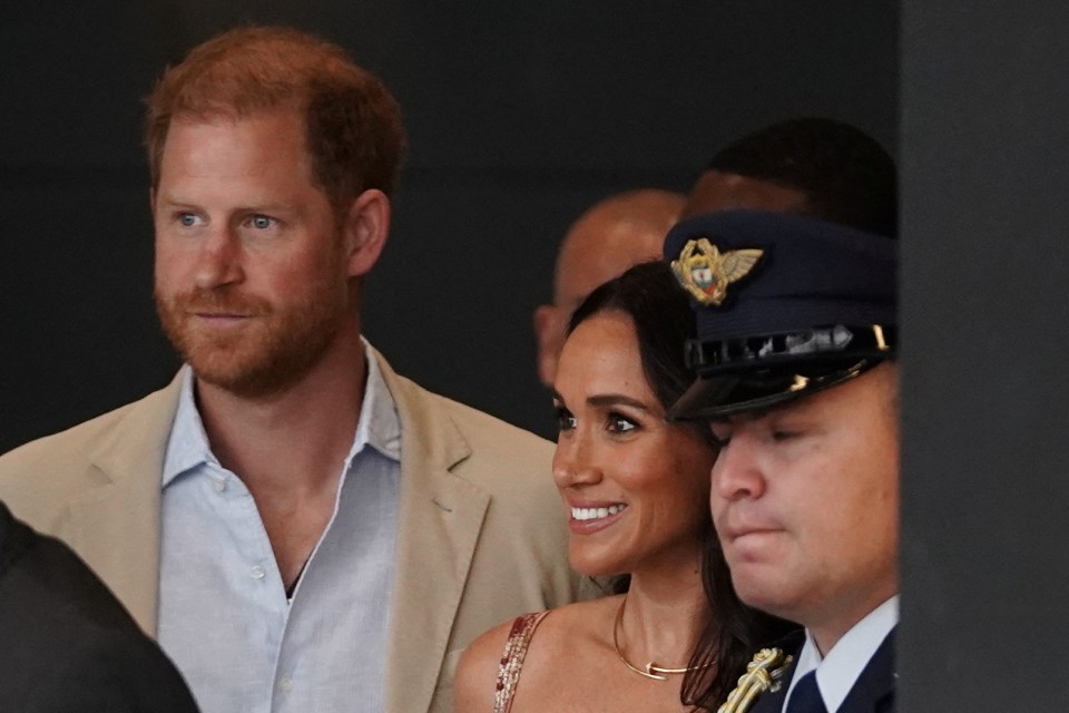 Harry and Meghan smile on during the first day of their Colombia tour