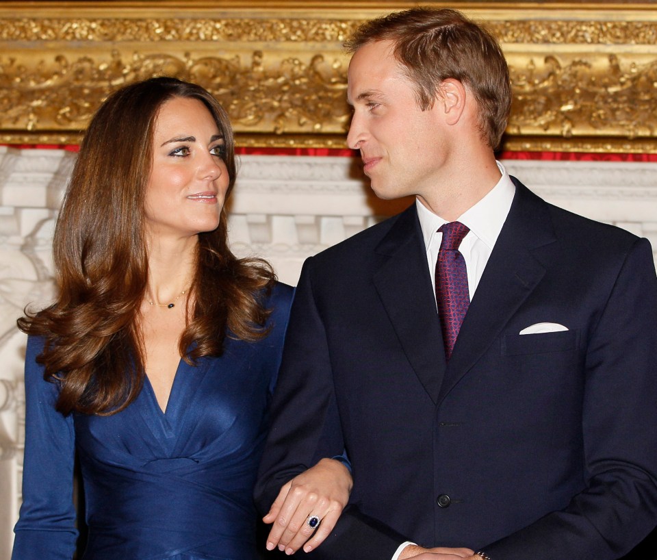 a man in a suit and tie stands next to a woman in a blue dress