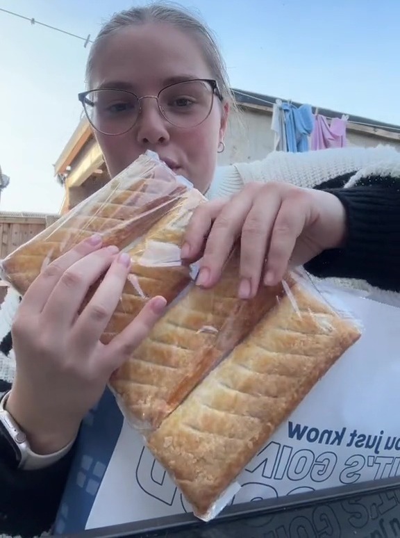 a woman eating a pastry with the words too good to go bag above her