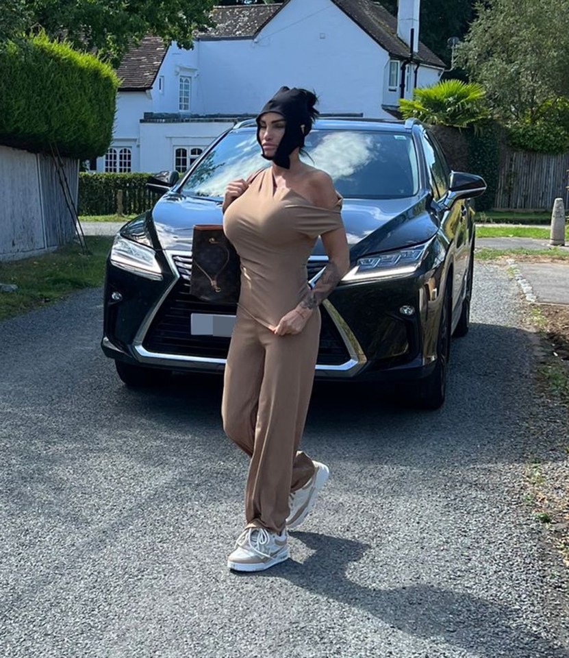 a woman is standing in front of a lexus car