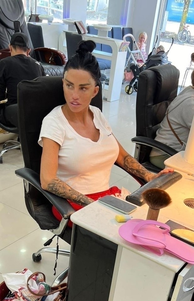 a woman sits in a chair in a nail salon