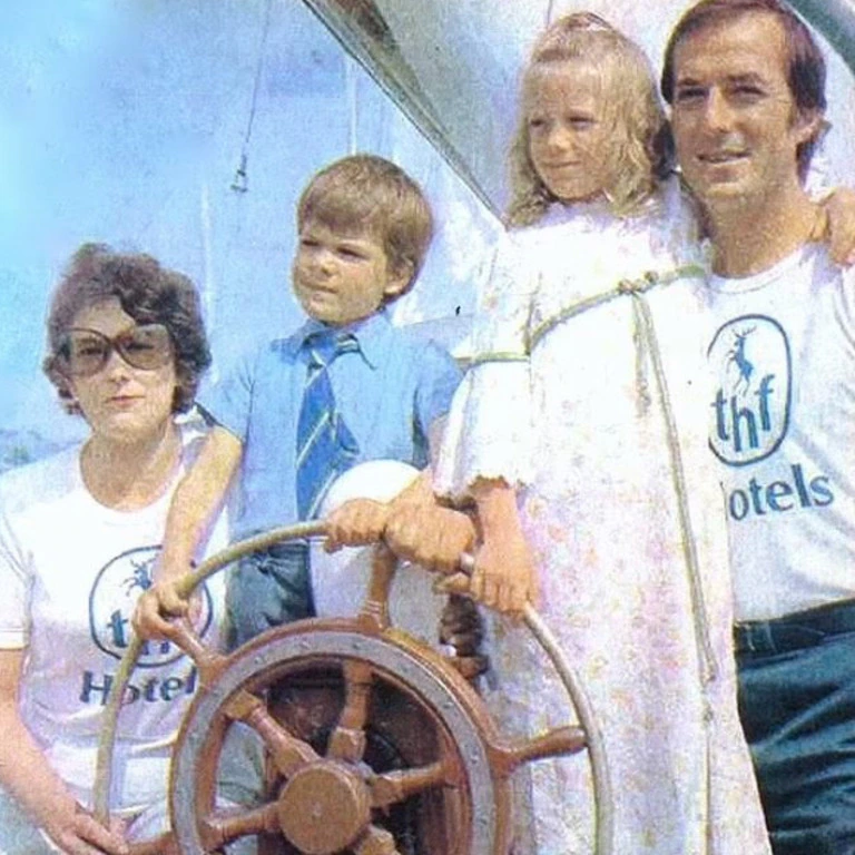 Suzanne is pictured above as a child with her parents and younger brother Jon on the sailing boat