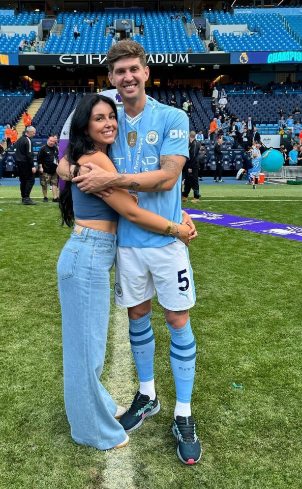 a man in a number 5 jersey stands on a field with a woman