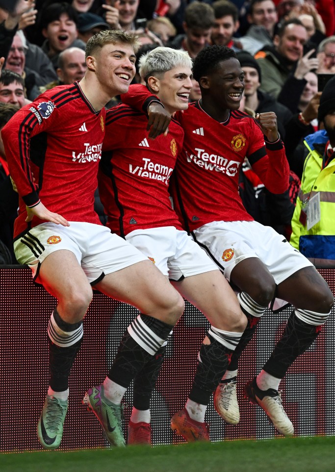 three soccer players wearing red jerseys with teamviewer on them