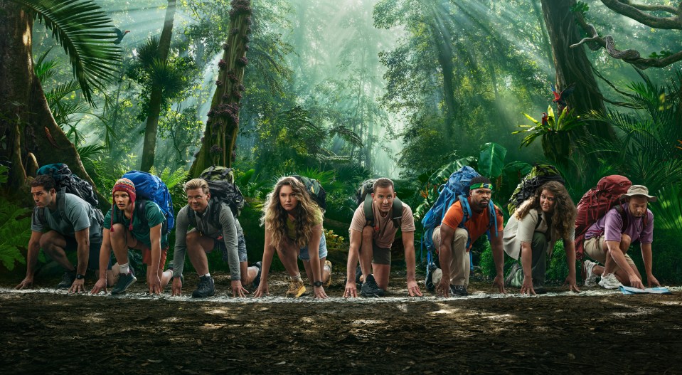 a group of people getting ready to run in the jungle