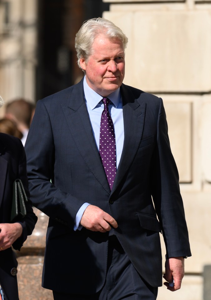 a man in a suit and tie is walking down the street