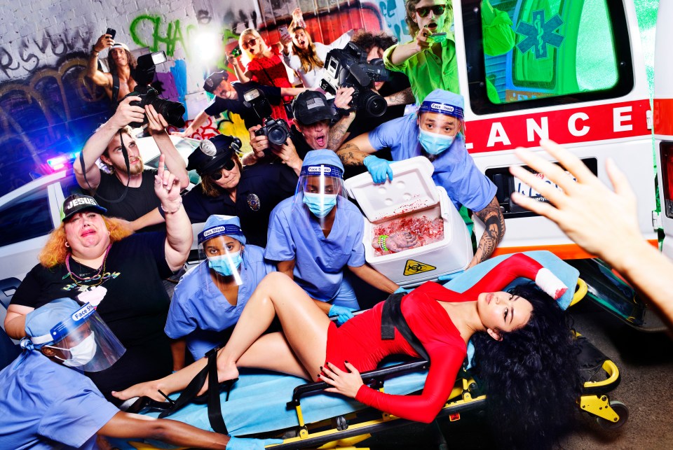 Charli posed on a stretcher while missing a hand