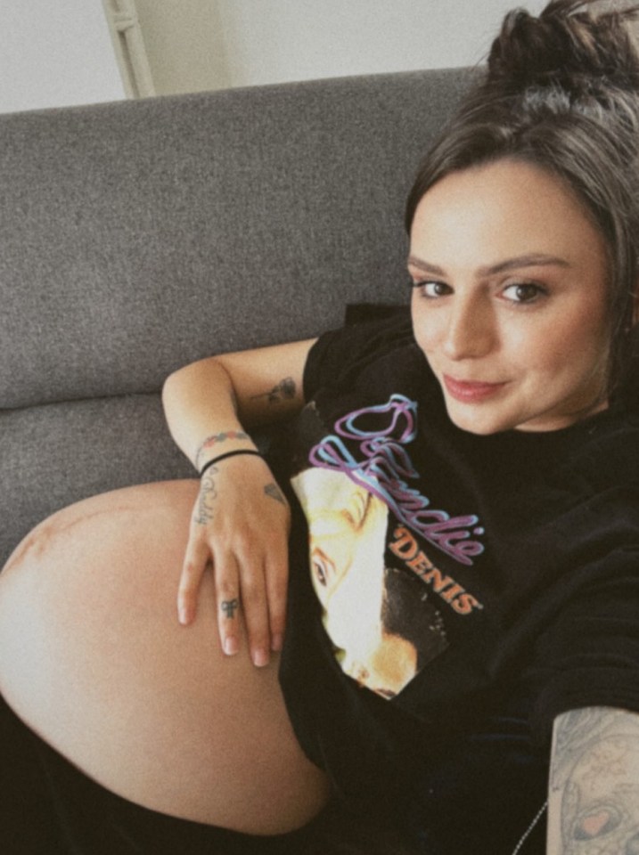 a pregnant woman wearing a t-shirt that says denis