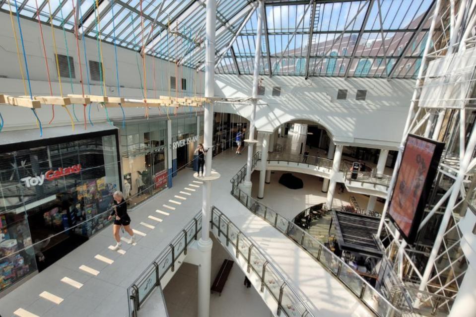 The attraction allows climbers to venture over any shoppers below