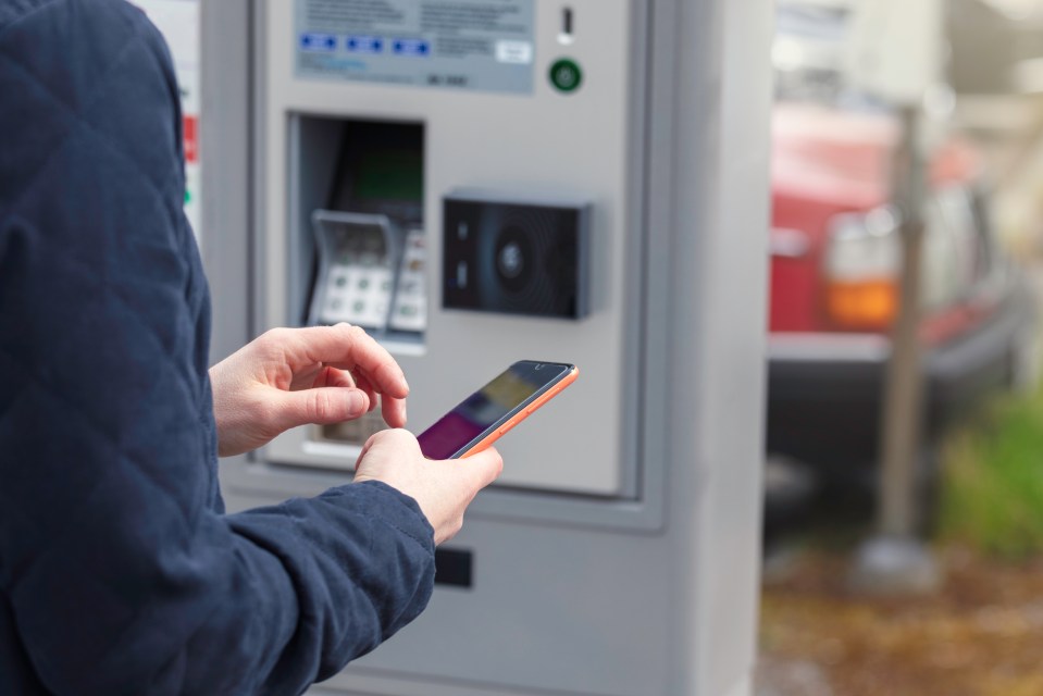 a person is using a smart phone to pay for parking