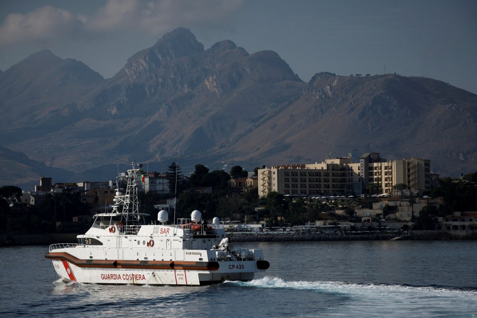 A Coast Guard vessel is pictured in front of the Domina Zagarella Sicily hotel where the survivors are staying