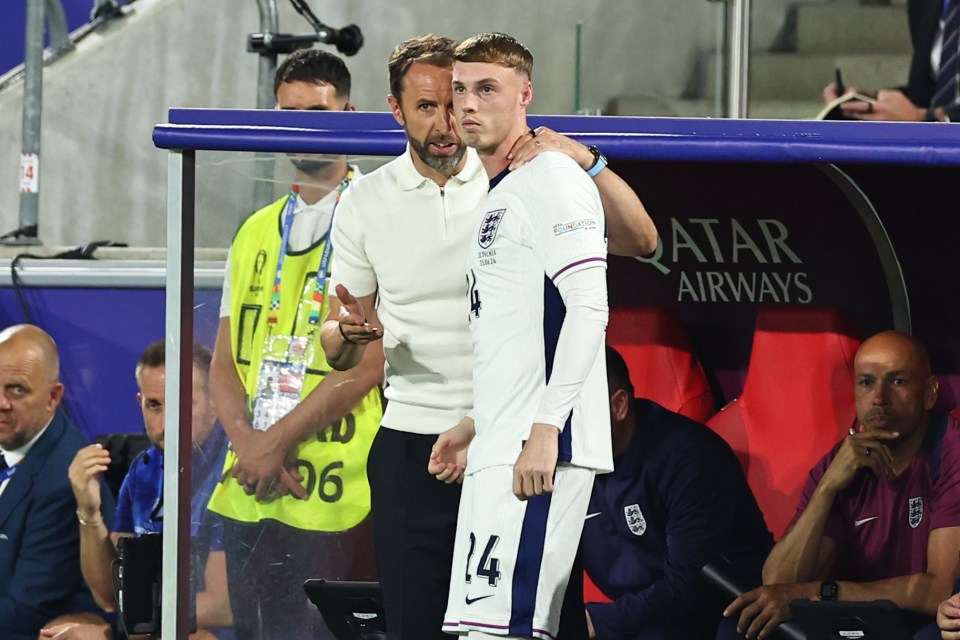 two soccer players standing in front of a dugout that says qatar airways