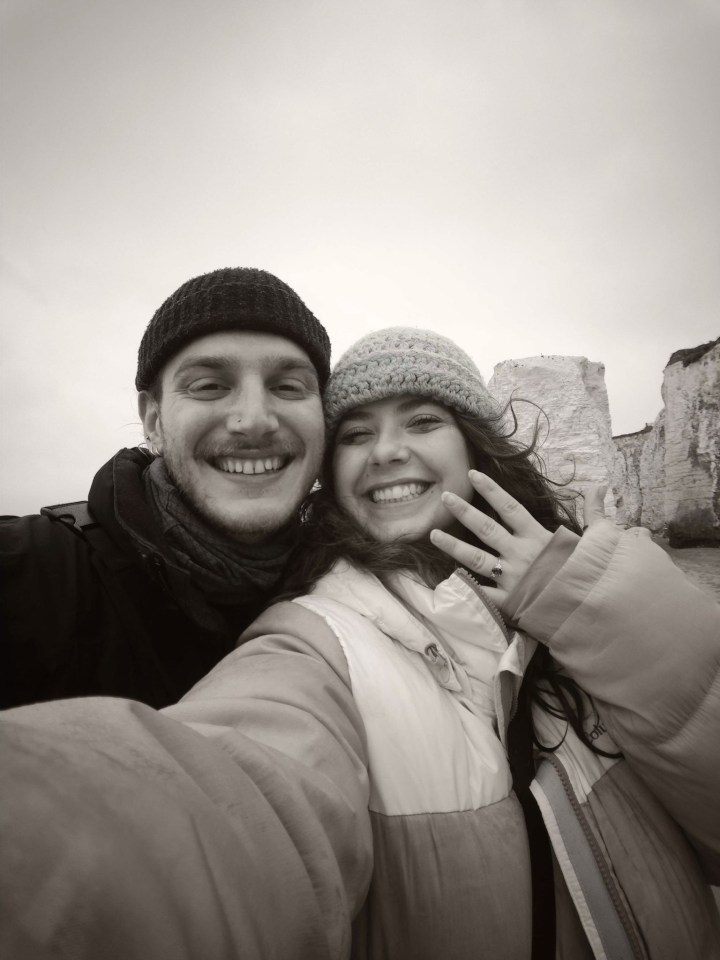 a black and white photo of a man and woman smiling