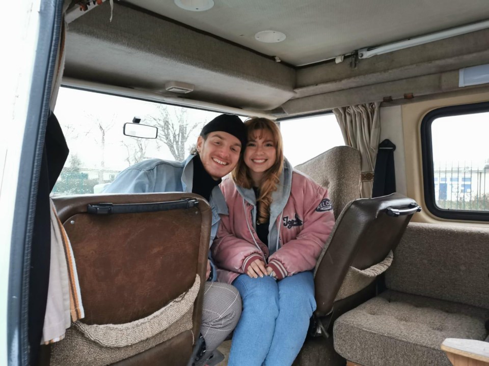 a man and a woman are sitting in the back seat of a van