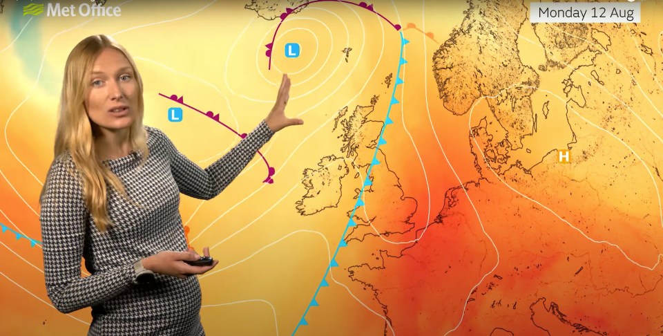 a woman stands in front of a met office weather map