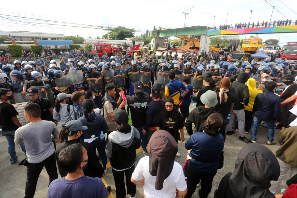 Over 2,000 officers are trying to enter an underground sex slave lair owned by the preacher but his loyal followers have formed a human shield to block them off