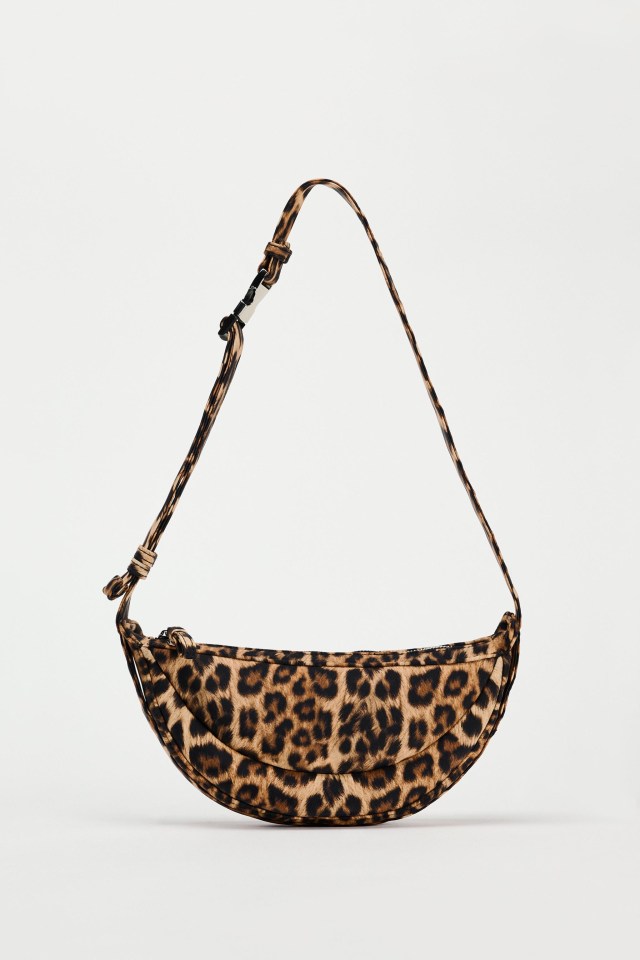 a leopard print purse with a long strap