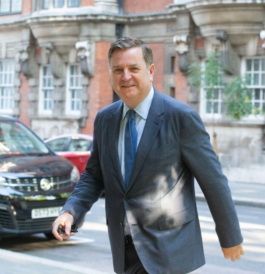 a man in a suit and tie is walking down the street