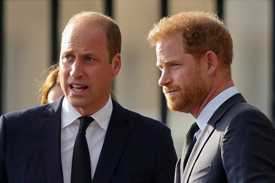 two men in suits are standing next to each other