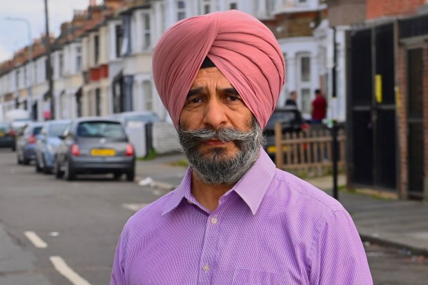 a man wearing a pink turban and a purple shirt