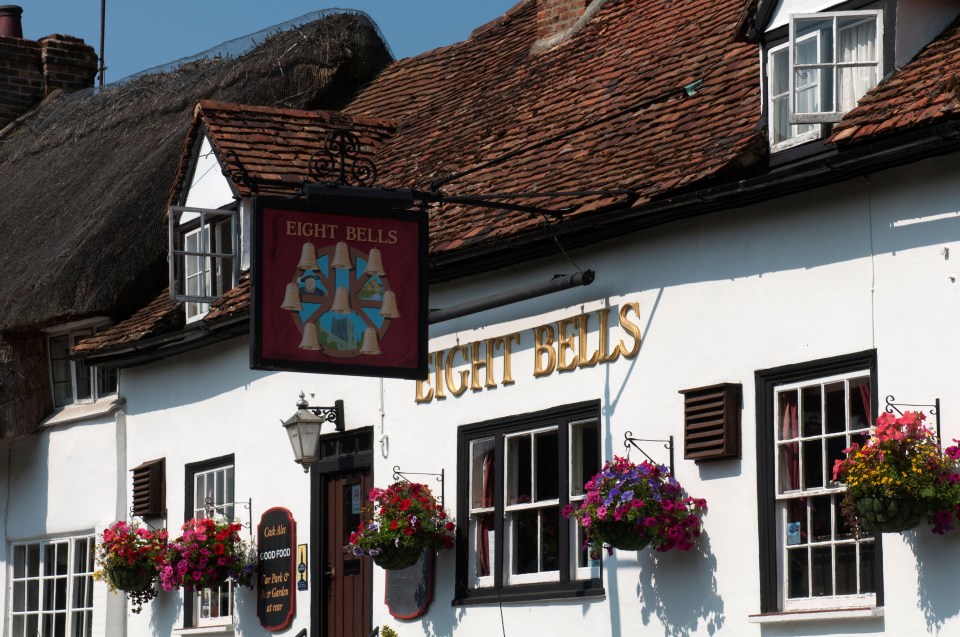 a white building with a sign that says eight bells