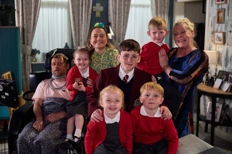 a family posing for a picture with a man in a wheelchair