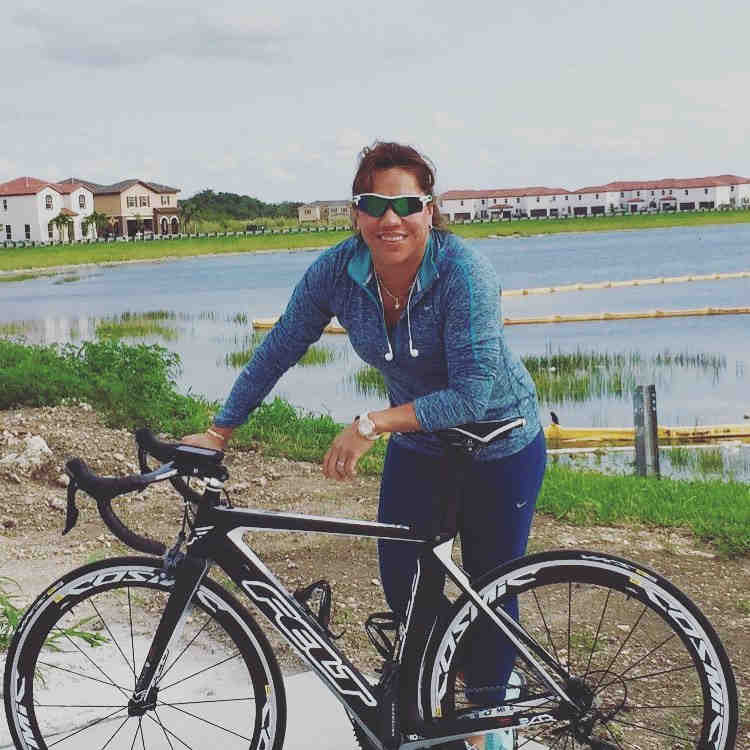 a woman stands next to a bicycle that says felt on the front