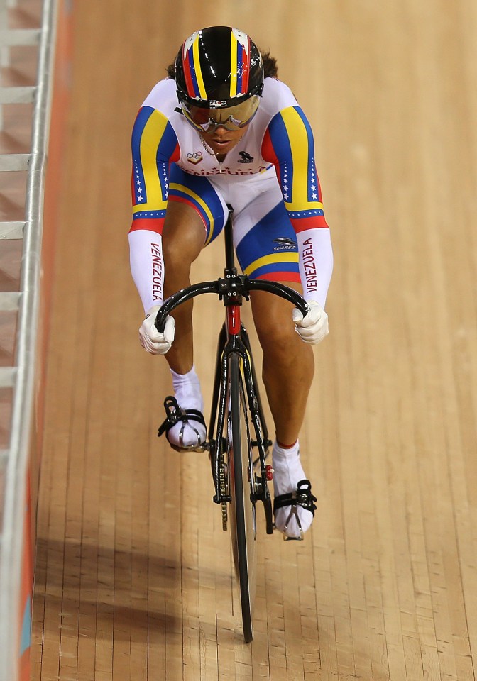 a woman riding a bike with venezuela on her sleeves