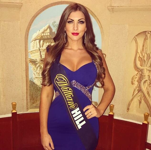 a woman in a blue dress is wearing a sash that says william hill