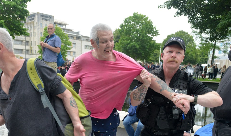 Daniel McGuire, 45, pictured in pink, was sentenced to 26 months today