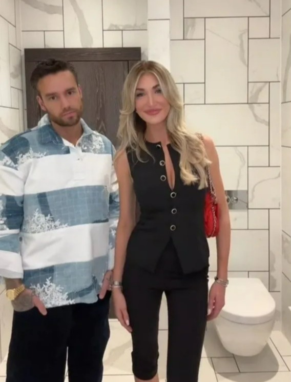 a man and a woman standing next to each other in a bathroom