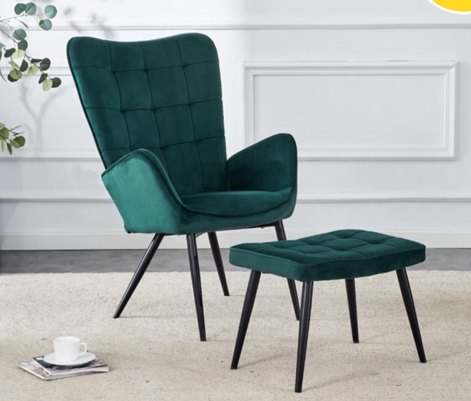 a green chair and ottoman sit on a white rug