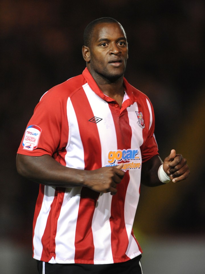 a man wearing a red and white striped shirt that says gocar on it