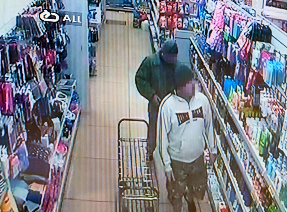 two men are walking down a store aisle with a sign that says all