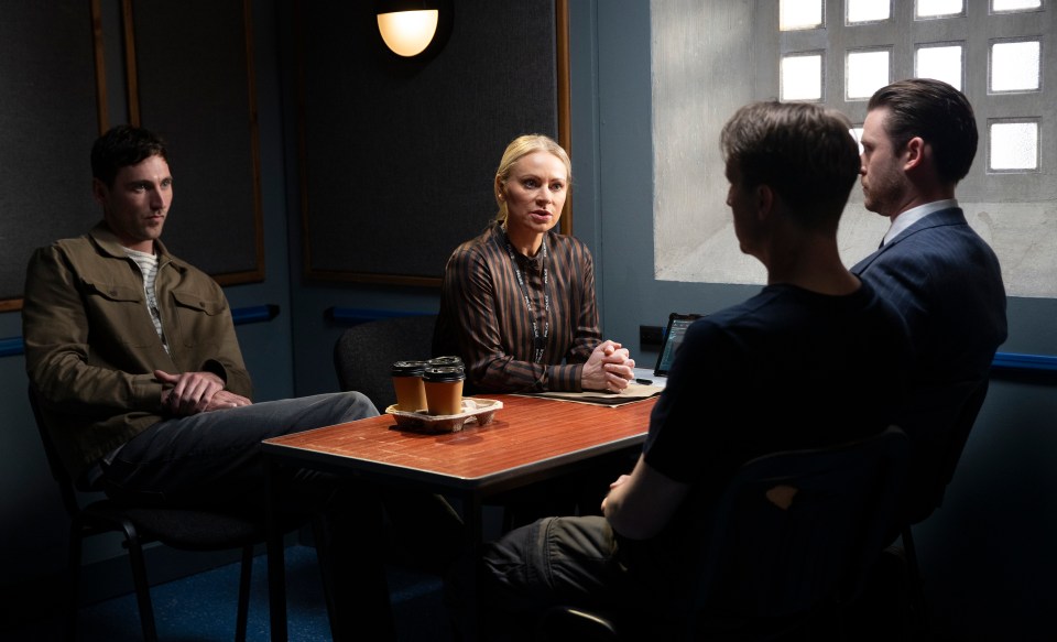 a group of people are sitting around a table with two cups of coffee on it