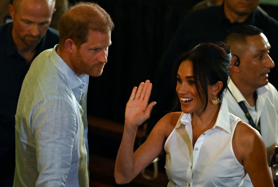 The Duchess of Sussex waves to crowds in Cali