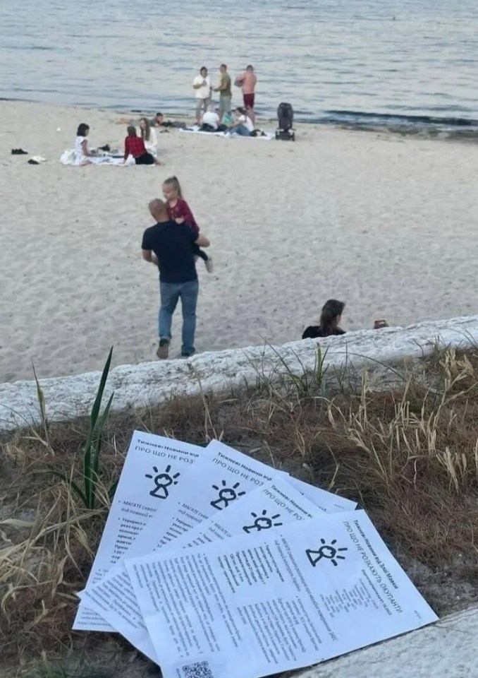 a stack of pamphlets on a beach that says ' i love you ' on them