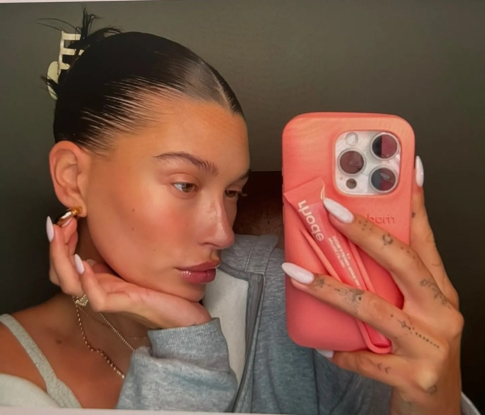 Hailey Bieber posts with her viral peach Rhode lip balm and phone case