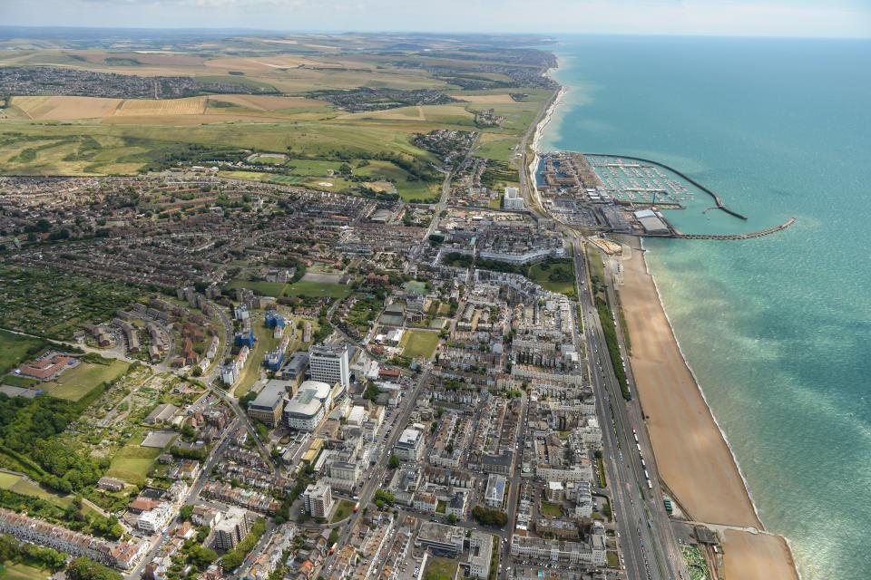 an aerial view of a city next to the ocean