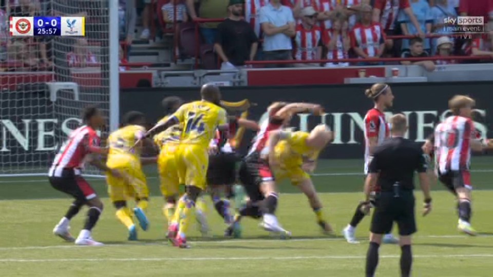 a group of soccer players on a field with the score 0-0